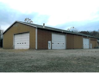 6.5 Acres including 13,176 sq. ft. commercial building in good condition.    Office area is 48' x 54', shop is 54' x 124'; and storage area is 54' x 72'.  

Office area is 2,592 sq. ft. with central air.  Natural gas heating.  Shop has floor drains and (2) overhead doors, used oil furnace, and large overhead hoist. - Commercial Building on 6.5 Acres