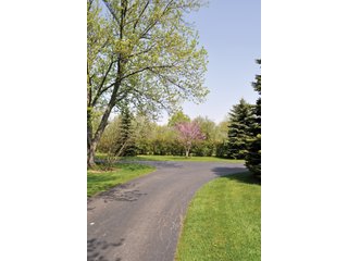 A very private setting with a unique view down the length of Shriner Lake.  Beautiful country setting with mature trees, great views of the lake from an elevated deck.  Road frontage on two sides!  Includes lovely orchard.  Great location close to Columbia City and Fort Wayne, - Lakefront Property on Shriner Lake
