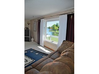 A very private setting with a unique view down the length of Shriner Lake.  Beautiful country setting with mature trees, great views of the lake from an elevated deck.  Road frontage on two sides!  Includes lovely orchard.  Great location close to Columbia City and Fort Wayne, - Lakefront Property on Shriner Lake