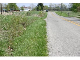 A gently rolling farm, just off of SR 205.  Includes frontage on the drainage ditch.  Per aerial map, Seller to retain 60' on east boundary of property and Seller to retain 60' easement on south side of ditch for ingress/egress. - 95 Acre Grain Farm