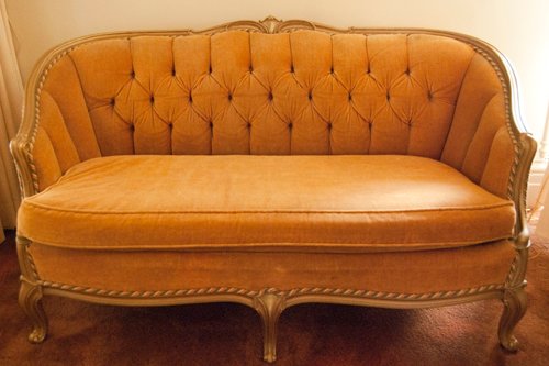 Pair of identical french provincial loveseat sofa ft.s. Wood framed. Apricot colored velvet upholstery. Channel and tufted. Dimensions 31 in. x 56 in. - Extraordinary Auction - Nike Spillson Home Interiors & Furnishings