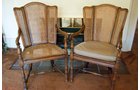 Pair of wingback fruitwood cane chairs with detachable leather cushion seats. - Extraordinary Auction - Nike Spillson Home Interiors & Furnishings