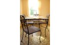 Woodard cast iron patio table 42 in. x 72 in. with 8 chairs. Plexiglas top. Two additional side tables. - Extraordinary Auction - Nike Spillson Home Interiors & Furnishings