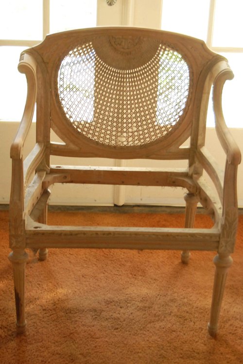 Cane back chair that matches cane back settee. Striped and unfinished. Comes with original padding.  27 in.W - Extraordinary Auction - Nike Spillson Home Interiors & Furnishings