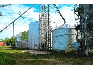 <b>TRACT #1 - GRAIN ELEVATOR</b>  (<b>SOLD - 9/9/16 $110,000</b>)
Note:  The grain bins, drier and legs are on R.R. leased property.  Mr. Voreis stated that lease payment is $900/year.

<b>Improvements - Grain Bins, Drier & Legs:</b>
1994     90,000 bu. bin with air tubes
1994     15,000 bu. hopper bin
               7,000 bu. bin
             42,000 bu. bin with air tube
<b>Drier:</b>  12'x45';1994 Zimmerman grain drier; S.S. 1,500 bu./hr. at 10 pts.;Natural gas
<b>Leg:</b>  1994 110' grain leg; 8,000 bu./hr.
<b>Drier Grain Leg:</b>  5,000 bu./hr.
<b>North Leg:</b>  7,000 bu./hr.
<b>Top Conveyor:</b>  1994 Chain Conveyor
<b>Bottom Conveyor:</b>  U-Trough Auger
<b>Dump Pit:</b>  Approx. 150 bu. with auger to leg

<b>Office:  Portable</b>  A 10' x 50' office with 2 separate offices, customer counter area, 1 restroom

<b>Grain Probe:</b>  A Hyd. Grain Probe

<b>Scales:</b>  10' x 60' Metal deck, scales, load cells, 100,000 lb. capacity, digital read-out and printer

<b>Quonset:</b>  A 41' x 120' metal Quonset building with concrete floor, top auger with 70,000 bu. capacity.

<b>Shop:</b>  A 22' x 40' wood frame with metal siding, concrete floor, heater

<b>Rail Siding:</b>  7+ Car rail siding along the east side of the grain bins.

<b>Utilities:</b>  City - Water and sewer; Electric - 480 (4) phase; Gas - Nipsco 

<FONT FACE="Arial, Helvetica, sans-serif" size="2" color="#0000FF"><b>TRACT #2 - STORAGE WAREHOUSE</b> (<b>STILL AVAILABLE</b>)

<b>2 Lots, Improvements</b>  60' x 112' wood frame structure, concrete floors, 4 doors, dock high load-out.</font face>



 - Grain Elevator (SOLD - 9/9/16) Storage Warehouse Still Available