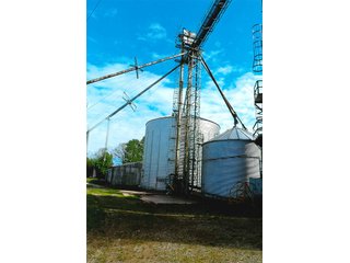 <b>TRACT #1 - GRAIN ELEVATOR</b>  (<b>SOLD - 9/9/16 $110,000</b>)
Note:  The grain bins, drier and legs are on R.R. leased property.  Mr. Voreis stated that lease payment is $900/year.

<b>Improvements - Grain Bins, Drier & Legs:</b>
1994     90,000 bu. bin with air tubes
1994     15,000 bu. hopper bin
               7,000 bu. bin
             42,000 bu. bin with air tube
<b>Drier:</b>  12'x45';1994 Zimmerman grain drier; S.S. 1,500 bu./hr. at 10 pts.;Natural gas
<b>Leg:</b>  1994 110' grain leg; 8,000 bu./hr.
<b>Drier Grain Leg:</b>  5,000 bu./hr.
<b>North Leg:</b>  7,000 bu./hr.
<b>Top Conveyor:</b>  1994 Chain Conveyor
<b>Bottom Conveyor:</b>  U-Trough Auger
<b>Dump Pit:</b>  Approx. 150 bu. with auger to leg

<b>Office:  Portable</b>  A 10' x 50' office with 2 separate offices, customer counter area, 1 restroom

<b>Grain Probe:</b>  A Hyd. Grain Probe

<b>Scales:</b>  10' x 60' Metal deck, scales, load cells, 100,000 lb. capacity, digital read-out and printer

<b>Quonset:</b>  A 41' x 120' metal Quonset building with concrete floor, top auger with 70,000 bu. capacity.

<b>Shop:</b>  A 22' x 40' wood frame with metal siding, concrete floor, heater

<b>Rail Siding:</b>  7+ Car rail siding along the east side of the grain bins.

<b>Utilities:</b>  City - Water and sewer; Electric - 480 (4) phase; Gas - Nipsco 

<FONT FACE="Arial, Helvetica, sans-serif" size="2" color="#0000FF"><b>TRACT #2 - STORAGE WAREHOUSE</b> (<b>STILL AVAILABLE</b>)

<b>2 Lots, Improvements</b>  60' x 112' wood frame structure, concrete floors, 4 doors, dock high load-out.</font face>



 - Grain Elevator (SOLD - 9/9/16) Storage Warehouse Still Available
