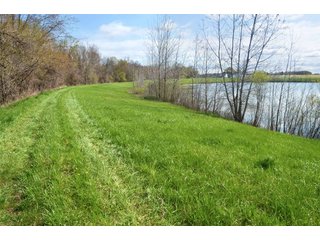 28.5+/- ACRES, a beautiful getaway featuring a well stocked 9 acre, 20+ foot deep lake stocked with bass, bluegill, and have caught large pike occasionally.  Formerly a gravel pit, this lake is bordered by groomed lawn grasses with a very large gravel beach to the lake for great swimming!!  A good sized metal building with covered porch, perfect for weekend and overnight stays.  Adjacent to the St. Joseph River with over 3,000 feet of river frontage, this property has wonderful scenic river views, where deer and turkey travel abundantly, and offers great duck and goose hunting on the lake!  
A great put-in site for river canoe and kayak trips, it offers a wonderful potential building site for year round home or private getaway!  And would also be a wonderful RV and Camper getaway spot!!  Only about a 40 minute drive from Fort Wayne, 30 minutes from Grabill, 20 minutes from Bryan, 35 minutes from Defiance, 30 minutes from Auburn! - 28.5+/- Acres with 9+/- acre Lake, Woods, Possible Building Sites
