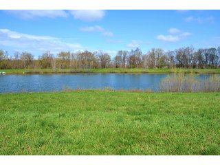 28.5+/- ACRES, a beautiful getaway featuring a well stocked 9 acre, 20+ foot deep lake stocked with bass, bluegill, and have caught large pike occasionally.  Formerly a gravel pit, this lake is bordered by groomed lawn grasses with a very large gravel beach to the lake for great swimming!!  A good sized metal building with covered porch, perfect for weekend and overnight stays.  Adjacent to the St. Joseph River with over 3,000 feet of river frontage, this property has wonderful scenic river views, where deer and turkey travel abundantly, and offers great duck and goose hunting on the lake!  
A great put-in site for river canoe and kayak trips, it offers a wonderful potential building site for year round home or private getaway!  And would also be a wonderful RV and Camper getaway spot!!  Only about a 40 minute drive from Fort Wayne, 30 minutes from Grabill, 20 minutes from Bryan, 35 minutes from Defiance, 30 minutes from Auburn! - 28.5+/- Acres with 9+/- acre Lake, Woods, Possible Building Sites