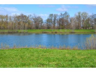 28.5+/- ACRES, a beautiful getaway featuring a well stocked 9 acre, 20+ foot deep lake stocked with bass, bluegill, and have caught large pike occasionally.  Formerly a gravel pit, this lake is bordered by groomed lawn grasses with a very large gravel beach to the lake for great swimming!!  A good sized metal building with covered porch, perfect for weekend and overnight stays.  Adjacent to the St. Joseph River with over 3,000 feet of river frontage, this property has wonderful scenic river views, where deer and turkey travel abundantly, and offers great duck and goose hunting on the lake!  
A great put-in site for river canoe and kayak trips, it offers a wonderful potential building site for year round home or private getaway!  And would also be a wonderful RV and Camper getaway spot!!  Only about a 40 minute drive from Fort Wayne, 30 minutes from Grabill, 20 minutes from Bryan, 35 minutes from Defiance, 30 minutes from Auburn! - 28.5+/- Acres with 9+/- acre Lake, Woods, Possible Building Sites