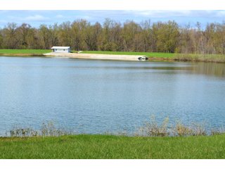 28.5+/- ACRES, a beautiful getaway featuring a well stocked 9 acre, 20+ foot deep lake stocked with bass, bluegill, and have caught large pike occasionally.  Formerly a gravel pit, this lake is bordered by groomed lawn grasses with a very large gravel beach to the lake for great swimming!!  A good sized metal building with covered porch, perfect for weekend and overnight stays.  Adjacent to the St. Joseph River with over 3,000 feet of river frontage, this property has wonderful scenic river views, where deer and turkey travel abundantly, and offers great duck and goose hunting on the lake!  
A great put-in site for river canoe and kayak trips, it offers a wonderful potential building site for year round home or private getaway!  And would also be a wonderful RV and Camper getaway spot!!  Only about a 40 minute drive from Fort Wayne, 30 minutes from Grabill, 20 minutes from Bryan, 35 minutes from Defiance, 30 minutes from Auburn! - 28.5+/- Acres with 9+/- acre Lake, Woods, Possible Building Sites