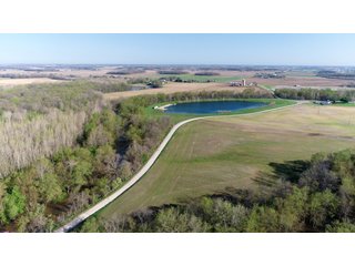 28.5+/- ACRES, a beautiful getaway featuring a well stocked 9 acre, 20+ foot deep lake stocked with bass, bluegill, and have caught large pike occasionally.  Formerly a gravel pit, this lake is bordered by groomed lawn grasses with a very large gravel beach to the lake for great swimming!!  A good sized metal building with covered porch, perfect for weekend and overnight stays.  Adjacent to the St. Joseph River with over 3,000 feet of river frontage, this property has wonderful scenic river views, where deer and turkey travel abundantly, and offers great duck and goose hunting on the lake!  
A great put-in site for river canoe and kayak trips, it offers a wonderful potential building site for year round home or private getaway!  And would also be a wonderful RV and Camper getaway spot!!  Only about a 40 minute drive from Fort Wayne, 30 minutes from Grabill, 20 minutes from Bryan, 35 minutes from Defiance, 30 minutes from Auburn! - 28.5+/- Acres with 9+/- acre Lake, Woods, Possible Building Sites