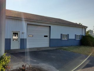 Beautiful country home. 2,692+/- finished sq. ft. home or a total of  3,588+/- sq. ft., 2 pole buildings 40'x75' & 50'x50' w/ interconnecting corridor, both heated & insulated. One has been used as a shop/storage/commercially & has water & rest room. The other has multi-uses w/ tile flooring, full bath & kitchenette great for get-togethers, auto storage & many other uses & a 32'x40' pole building w/ gravel floor great for horses & livestock or extra storage, an additional separate 2 car garage. The home has had many updates most noticeably a totally remodeled master suite, flooring throughout the home, a second main floor bedroom w/ walkout deck & patio, there is a 3rd bedroom, upstairs & large landing w/ room for an extra bed. One & a half baths, large living room, sliding door to deck & patio. Eat in kitchen w/ appliances, a separate dining area. Central air & heat pump. Shady rear patio & deck. The basement is partially finished. There are many updates & amenities too numerous to mention & must be seen in person. A great property for storage, business, hobbies and/or livestock. Stocked fish pond, pasture & potential building site. Come & investigate the potential. - REAL ESTATE FOR SALE - 10.2+/- ACRES IN WHITLEY COUNTY INDIANA