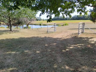 Beautiful country home. 2,692+/- finished sq. ft. home or a total of  3,588+/- sq. ft., 2 pole buildings 40'x75' & 50'x50' w/ interconnecting corridor, both heated & insulated. One has been used as a shop/storage/commercially & has water & rest room. The other has multi-uses w/ tile flooring, full bath & kitchenette great for get-togethers, auto storage & many other uses & a 32'x40' pole building w/ gravel floor great for horses & livestock or extra storage, an additional separate 2 car garage. The home has had many updates most noticeably a totally remodeled master suite, flooring throughout the home, a second main floor bedroom w/ walkout deck & patio, there is a 3rd bedroom, upstairs & large landing w/ room for an extra bed. One & a half baths, large living room, sliding door to deck & patio. Eat in kitchen w/ appliances, a separate dining area. Central air & heat pump. Shady rear patio & deck. The basement is partially finished. There are many updates & amenities too numerous to mention & must be seen in person. A great property for storage, business, hobbies and/or livestock. Stocked fish pond, pasture & potential building site. Come & investigate the potential. - REAL ESTATE FOR SALE - 10.2+/- ACRES IN WHITLEY COUNTY INDIANA