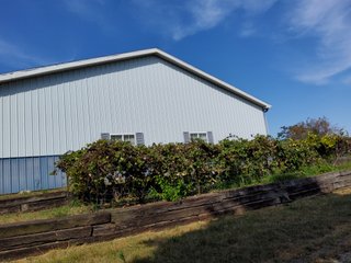 Beautiful country home. 2,692+/- finished sq. ft. home or a total of  3,588+/- sq. ft., 2 pole buildings 40'x75' & 50'x50' w/ interconnecting corridor, both heated & insulated. One has been used as a shop/storage/commercially & has water & rest room. The other has multi-uses w/ tile flooring, full bath & kitchenette great for get-togethers, auto storage & many other uses & a 32'x40' pole building w/ gravel floor great for horses & livestock or extra storage, an additional separate 2 car garage. The home has had many updates most noticeably a totally remodeled master suite, flooring throughout the home, a second main floor bedroom w/ walkout deck & patio, there is a 3rd bedroom, upstairs & large landing w/ room for an extra bed. One & a half baths, large living room, sliding door to deck & patio. Eat in kitchen w/ appliances, a separate dining area. Central air & heat pump. Shady rear patio & deck. The basement is partially finished. There are many updates & amenities too numerous to mention & must be seen in person. A great property for storage, business, hobbies and/or livestock. Stocked fish pond, pasture & potential building site. Come & investigate the potential. - REAL ESTATE FOR SALE - 10.2+/- ACRES IN WHITLEY COUNTY INDIANA