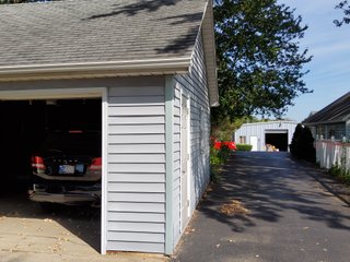 Beautiful country home. 2,692+/- finished sq. ft. home or a total of  3,588+/- sq. ft., 2 pole buildings 40'x75' & 50'x50' w/ interconnecting corridor, both heated & insulated. One has been used as a shop/storage/commercially & has water & rest room. The other has multi-uses w/ tile flooring, full bath & kitchenette great for get-togethers, auto storage & many other uses & a 32'x40' pole building w/ gravel floor great for horses & livestock or extra storage, an additional separate 2 car garage. The home has had many updates most noticeably a totally remodeled master suite, flooring throughout the home, a second main floor bedroom w/ walkout deck & patio, there is a 3rd bedroom, upstairs & large landing w/ room for an extra bed. One & a half baths, large living room, sliding door to deck & patio. Eat in kitchen w/ appliances, a separate dining area. Central air & heat pump. Shady rear patio & deck. The basement is partially finished. There are many updates & amenities too numerous to mention & must be seen in person. A great property for storage, business, hobbies and/or livestock. Stocked fish pond, pasture & potential building site. Come & investigate the potential. - REAL ESTATE FOR SALE - 10.2+/- ACRES IN WHITLEY COUNTY INDIANA