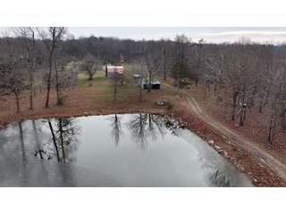 This 153+/- acre piece located in Mammoth Cave, KY sits in Edmonson County and borders the famous Mammoth Cave National Park. Any avid outdoorsman will quickly grow to admire this rural masterpiece and the natural beauty it provides. The property features numerous ponds, abundant wooded area suitable for hunting, and more. The primary dwelling measures 1,840 square feet and consists of three bedrooms, two bathrooms, and an unfinished basement. The dwelling also contains a 640 square foot two car attached garage. Additionally, a small hunting type cabin is present on the property as well as a utility barn for storage or other purposes. Furthermore, the property is within close proximity to a wide variety of attractions, such as Mammoth Cave, Nolin Lake, Blue Holler Off-Road Park, Mammoth Cave Horse Camp and much more. A wonderful opportunity for anyone looking for their ideal outdoor escape! - A Beautiful Setting in the Hills of South Central Kentucky!!