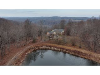This 153+/- acre piece located in Mammoth Cave, KY sits in Edmonson County and borders the famous Mammoth Cave National Park. Any avid outdoorsman will quickly grow to admire this rural masterpiece and the natural beauty it provides. The property features numerous ponds, abundant wooded area suitable for hunting, and more. The primary dwelling measures 1,840 square feet and consists of three bedrooms, two bathrooms, and an unfinished basement. The dwelling also contains a 640 square foot two car attached garage. Additionally, a small hunting type cabin is present on the property as well as a utility barn for storage or other purposes. Furthermore, the property is within close proximity to a wide variety of attractions, such as Mammoth Cave, Nolin Lake, Blue Holler Off-Road Park, Mammoth Cave Horse Camp and much more. A wonderful opportunity for anyone looking for their ideal outdoor escape! - A Beautiful Setting in the Hills of South Central Kentucky!!
