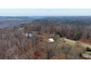 This 153+/- acre piece located in Mammoth Cave, KY sits in Edmonson County and borders the famous Mammoth Cave National Park. Any avid outdoorsman will quickly grow to admire this rural masterpiece and the natural beauty it provides. The property features numerous ponds, abundant wooded area suitable for hunting, and more. The primary dwelling measures 1,840 square feet and consists of three bedrooms, two bathrooms, and an unfinished basement. The dwelling also contains a 640 square foot two car attached garage. Additionally, a small hunting type cabin is present on the property as well as a utility barn for storage or other purposes. Furthermore, the property is within close proximity to a wide variety of attractions, such as Mammoth Cave, Nolin Lake, Blue Holler Off-Road Park, Mammoth Cave Horse Camp and much more. A wonderful opportunity for anyone looking for their ideal outdoor escape! - A Beautiful Setting in the Hills of South Central Kentucky!!