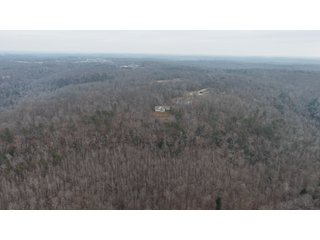 This 153+/- acre piece located in Mammoth Cave, KY sits in Edmonson County and borders the famous Mammoth Cave National Park. Any avid outdoorsman will quickly grow to admire this rural masterpiece and the natural beauty it provides. The property features numerous ponds, abundant wooded area suitable for hunting, and more. The primary dwelling measures 1,840 square feet and consists of three bedrooms, two bathrooms, and an unfinished basement. The dwelling also contains a 640 square foot two car attached garage. Additionally, a small hunting type cabin is present on the property as well as a utility barn for storage or other purposes. Furthermore, the property is within close proximity to a wide variety of attractions, such as Mammoth Cave, Nolin Lake, Blue Holler Off-Road Park, Mammoth Cave Horse Camp and much more. A wonderful opportunity for anyone looking for their ideal outdoor escape! - A Beautiful Setting in the Hills of South Central Kentucky!!
