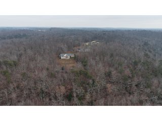 This 153+/- acre piece located in Mammoth Cave, KY sits in Edmonson County and borders the famous Mammoth Cave National Park. Any avid outdoorsman will quickly grow to admire this rural masterpiece and the natural beauty it provides. The property features numerous ponds, abundant wooded area suitable for hunting, and more. The primary dwelling measures 1,840 square feet and consists of three bedrooms, two bathrooms, and an unfinished basement. The dwelling also contains a 640 square foot two car attached garage. Additionally, a small hunting type cabin is present on the property as well as a utility barn for storage or other purposes. Furthermore, the property is within close proximity to a wide variety of attractions, such as Mammoth Cave, Nolin Lake, Blue Holler Off-Road Park, Mammoth Cave Horse Camp and much more. A wonderful opportunity for anyone looking for their ideal outdoor escape! - A Beautiful Setting in the Hills of South Central Kentucky!!