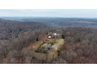 This 153+/- acre piece located in Mammoth Cave, KY sits in Edmonson County and borders the famous Mammoth Cave National Park. Any avid outdoorsman will quickly grow to admire this rural masterpiece and the natural beauty it provides. The property features numerous ponds, abundant wooded area suitable for hunting, and more. The primary dwelling measures 1,840 square feet and consists of three bedrooms, two bathrooms, and an unfinished basement. The dwelling also contains a 640 square foot two car attached garage. Additionally, a small hunting type cabin is present on the property as well as a utility barn for storage or other purposes. Furthermore, the property is within close proximity to a wide variety of attractions, such as Mammoth Cave, Nolin Lake, Blue Holler Off-Road Park, Mammoth Cave Horse Camp and much more. A wonderful opportunity for anyone looking for their ideal outdoor escape! - A Beautiful Setting in the Hills of South Central Kentucky!!