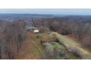 This 153+/- acre piece located in Mammoth Cave, KY sits in Edmonson County and borders the famous Mammoth Cave National Park. Any avid outdoorsman will quickly grow to admire this rural masterpiece and the natural beauty it provides. The property features numerous ponds, abundant wooded area suitable for hunting, and more. The primary dwelling measures 1,840 square feet and consists of three bedrooms, two bathrooms, and an unfinished basement. The dwelling also contains a 640 square foot two car attached garage. Additionally, a small hunting type cabin is present on the property as well as a utility barn for storage or other purposes. Furthermore, the property is within close proximity to a wide variety of attractions, such as Mammoth Cave, Nolin Lake, Blue Holler Off-Road Park, Mammoth Cave Horse Camp and much more. A wonderful opportunity for anyone looking for their ideal outdoor escape! - A Beautiful Setting in the Hills of South Central Kentucky!!