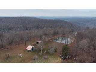 This 153+/- acre piece located in Mammoth Cave, KY sits in Edmonson County and borders the famous Mammoth Cave National Park. Any avid outdoorsman will quickly grow to admire this rural masterpiece and the natural beauty it provides. The property features numerous ponds, abundant wooded area suitable for hunting, and more. The primary dwelling measures 1,840 square feet and consists of three bedrooms, two bathrooms, and an unfinished basement. The dwelling also contains a 640 square foot two car attached garage. Additionally, a small hunting type cabin is present on the property as well as a utility barn for storage or other purposes. Furthermore, the property is within close proximity to a wide variety of attractions, such as Mammoth Cave, Nolin Lake, Blue Holler Off-Road Park, Mammoth Cave Horse Camp and much more. A wonderful opportunity for anyone looking for their ideal outdoor escape! - A Beautiful Setting in the Hills of South Central Kentucky!!