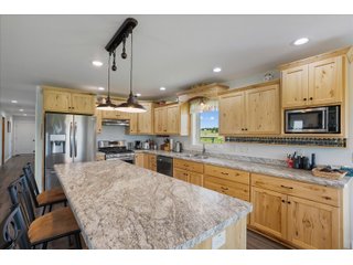 <B><font color=red>STILL ACCEPTING OFFERS</FONT></B>


Schrader Real Estate & Auction Co is pleased to present this unique real estate opportunity comprised of a beautiful custom-built home, scenic pond, large machine shed and barn, all sitting on 34+/- acres. Enjoy your morning coffee from the spacious kitchen or covered deck while seeing wildlife in the fields and pond. This setting offers both the enjoyment of relaxing by yourself or hosting large gatherings with friends and family in the finished basement or large outdoor patio with over 1,000 sq ft of outdoor finished space. Get ready to enjoy all the benefits of being in the country with both the machine shed that has a heated office or in the barn set up for your choice of any type of livestock. With the barn having concrete floor and fully insulated, this can easily be converted to a shop or storage. <br>
<li>	Built in 2021
<li>	Oversized 3-Car Garage
<li>	Custom made Cabinets and Vanities
<li>	Stainless steel appliances
<li>	Gas and Electric hookup for Stove and Dryer
<li>	Gas hookup for Living Room Fireplace
<li>	Sky lights in Master and Main bathroom
<li>	Finished Heated garage with floor drain and heavy duty wiring and receptacles 
<li>	Freestanding wood/coal Stove in living room (No electric needed)
<li>	Covered front porch, covered deck, and outdoor patio (partially covered)
<li>	Fruit/Root Cellar with Ample Shelving
<li>	Dual zone Upstairs/Downstairs energy efficient LP furnace
<li>	Whole house generator Hookup with Interlock System
<li>	R-24 sidewall/R-60 Ceiling dense pack insulation in House & Garage
<li>	Basement Spray Foamed (Walls and Box Sills)
<li>	All open windows are casement
<li>	Beautiful knotty pine ceilings on both Covered Deck and Porch
<li>	Maintenance-Free siding and decking
<li>	Cement Front porch and sidewalk to patio
<li>	Hookups for big screen in living room, Master bedroom, and Basement
<li>	120 ft drilled well 15 GPM that serves house, barn, shed, and garden
<li>	All underground wiring
<li>	Frost-free hydrant next to fertile mound garden
<li>	Small apple and pear orchard 
<li>	Landscape included trees and perennials for low maintenance 
<li>	Over 300 trees and shrubs in spacious yard 
<li>	Over 150 trees and shrubs under dripline
<li>	Approximately 0.75-acre pond 16 feet deep on far end with rock spillway
<li>	Entire driveway covered with blue rock
<li>	Frostless faucets on three sides of house
<li>	Outside receptacles on all four sides of house (eight total)
<li>	Small porch off laundry room with maintenance free decking
<li>	Battery backup sump pump that very rarely turns on
<li>	All high tensile woven wire fencing with six separated pasture and paddocks - REAL ESTATE FOR SALE 34+/- ACRES IN MARATHON COUNTY, WISCONSIN