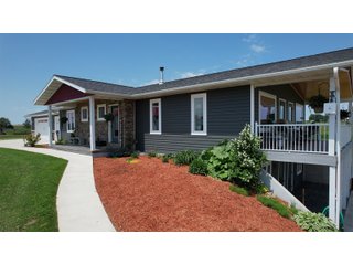 <B><font color=red>STILL ACCEPTING OFFERS</FONT></B>


Schrader Real Estate & Auction Co is pleased to present this unique real estate opportunity comprised of a beautiful custom-built home, scenic pond, large machine shed and barn, all sitting on 34+/- acres. Enjoy your morning coffee from the spacious kitchen or covered deck while seeing wildlife in the fields and pond. This setting offers both the enjoyment of relaxing by yourself or hosting large gatherings with friends and family in the finished basement or large outdoor patio with over 1,000 sq ft of outdoor finished space. Get ready to enjoy all the benefits of being in the country with both the machine shed that has a heated office or in the barn set up for your choice of any type of livestock. With the barn having concrete floor and fully insulated, this can easily be converted to a shop or storage. <br>
<li>	Built in 2021
<li>	Oversized 3-Car Garage
<li>	Custom made Cabinets and Vanities
<li>	Stainless steel appliances
<li>	Gas and Electric hookup for Stove and Dryer
<li>	Gas hookup for Living Room Fireplace
<li>	Sky lights in Master and Main bathroom
<li>	Finished Heated garage with floor drain and heavy duty wiring and receptacles 
<li>	Freestanding wood/coal Stove in living room (No electric needed)
<li>	Covered front porch, covered deck, and outdoor patio (partially covered)
<li>	Fruit/Root Cellar with Ample Shelving
<li>	Dual zone Upstairs/Downstairs energy efficient LP furnace
<li>	Whole house generator Hookup with Interlock System
<li>	R-24 sidewall/R-60 Ceiling dense pack insulation in House & Garage
<li>	Basement Spray Foamed (Walls and Box Sills)
<li>	All open windows are casement
<li>	Beautiful knotty pine ceilings on both Covered Deck and Porch
<li>	Maintenance-Free siding and decking
<li>	Cement Front porch and sidewalk to patio
<li>	Hookups for big screen in living room, Master bedroom, and Basement
<li>	120 ft drilled well 15 GPM that serves house, barn, shed, and garden
<li>	All underground wiring
<li>	Frost-free hydrant next to fertile mound garden
<li>	Small apple and pear orchard 
<li>	Landscape included trees and perennials for low maintenance 
<li>	Over 300 trees and shrubs in spacious yard 
<li>	Over 150 trees and shrubs under dripline
<li>	Approximately 0.75-acre pond 16 feet deep on far end with rock spillway
<li>	Entire driveway covered with blue rock
<li>	Frostless faucets on three sides of house
<li>	Outside receptacles on all four sides of house (eight total)
<li>	Small porch off laundry room with maintenance free decking
<li>	Battery backup sump pump that very rarely turns on
<li>	All high tensile woven wire fencing with six separated pasture and paddocks - REAL ESTATE FOR SALE 34+/- ACRES IN MARATHON COUNTY, WISCONSIN