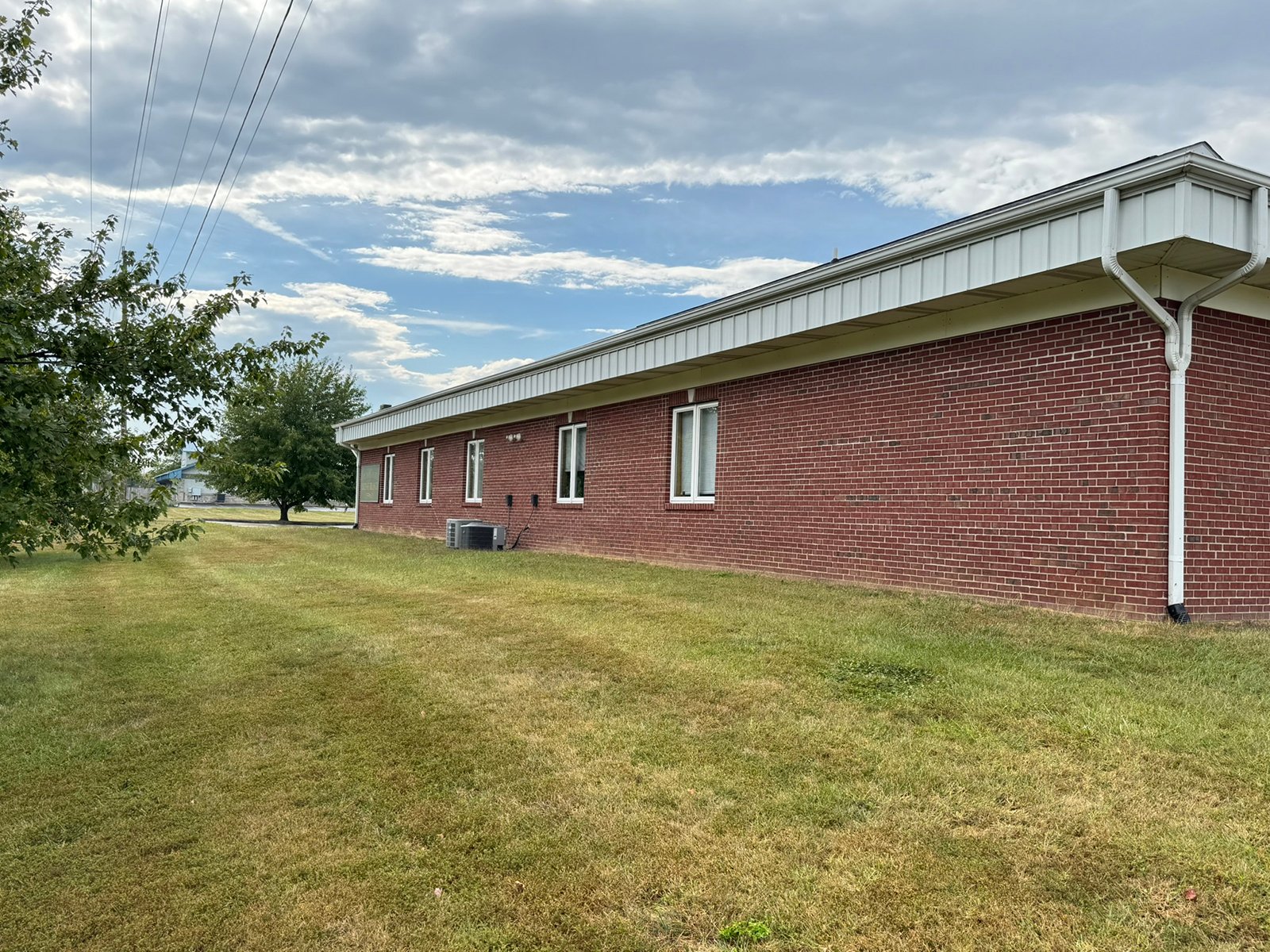 Outstanding opportunity to acquire a commercial property in Greencastle, IN with a proven long-term tenant. This site has been home to the Indiana Bureau of Motor Vehicles for more than 20 years under a favorable lease, ensuring minimal landlord responsibilities. With the current tenant there are no real estate taxes on the property.
The property spans 0.98+/- acres and includes a 4,947+/- sq ft building, built in 2004, along with a 15,180+/- sq ft parking lot providing ample customer convenience. The location is excellent - situated in Greencastle  Township, just East of Greencastle High School. With easy access from Veterans Memorial Highway (US-231) via Mill Pond Drive, the site benefits from both visibility and accessibility.
With a strong, creditworthy tenant and reliable cash flow, this property is an ideal choice for investors looking for secure, long-term income in a community-centered market. - COMMERCIAL REAL ESTATE FOR SALE - .98+/-ACRES IN PUTNAM COUNTY, INDIANA