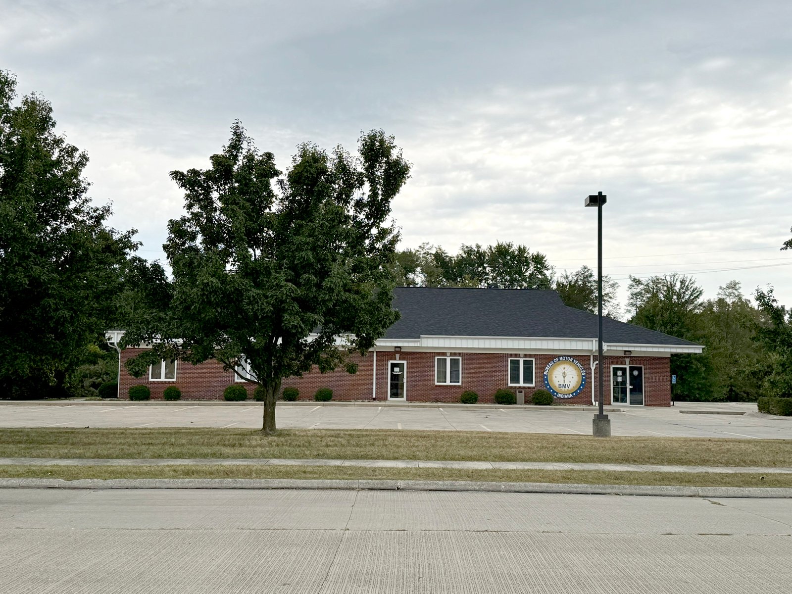 Outstanding opportunity to acquire a commercial property in Greencastle, IN with a proven long-term tenant. This site has been home to the Indiana Bureau of Motor Vehicles for more than 20 years under a favorable lease, ensuring minimal landlord responsibilities. With the current tenant there are no real estate taxes on the property.
The property spans 0.98+/- acres and includes a 4,947+/- sq ft building, built in 2004, along with a 15,180+/- sq ft parking lot providing ample customer convenience. The location is excellent - situated in Greencastle  Township, just East of Greencastle High School. With easy access from Veterans Memorial Highway (US-231) via Mill Pond Drive, the site benefits from both visibility and accessibility.
With a strong, creditworthy tenant and reliable cash flow, this property is an ideal choice for investors looking for secure, long-term income in a community-centered market. - COMMERCIAL REAL ESTATE FOR SALE - .98+/-ACRES IN PUTNAM COUNTY, INDIANA