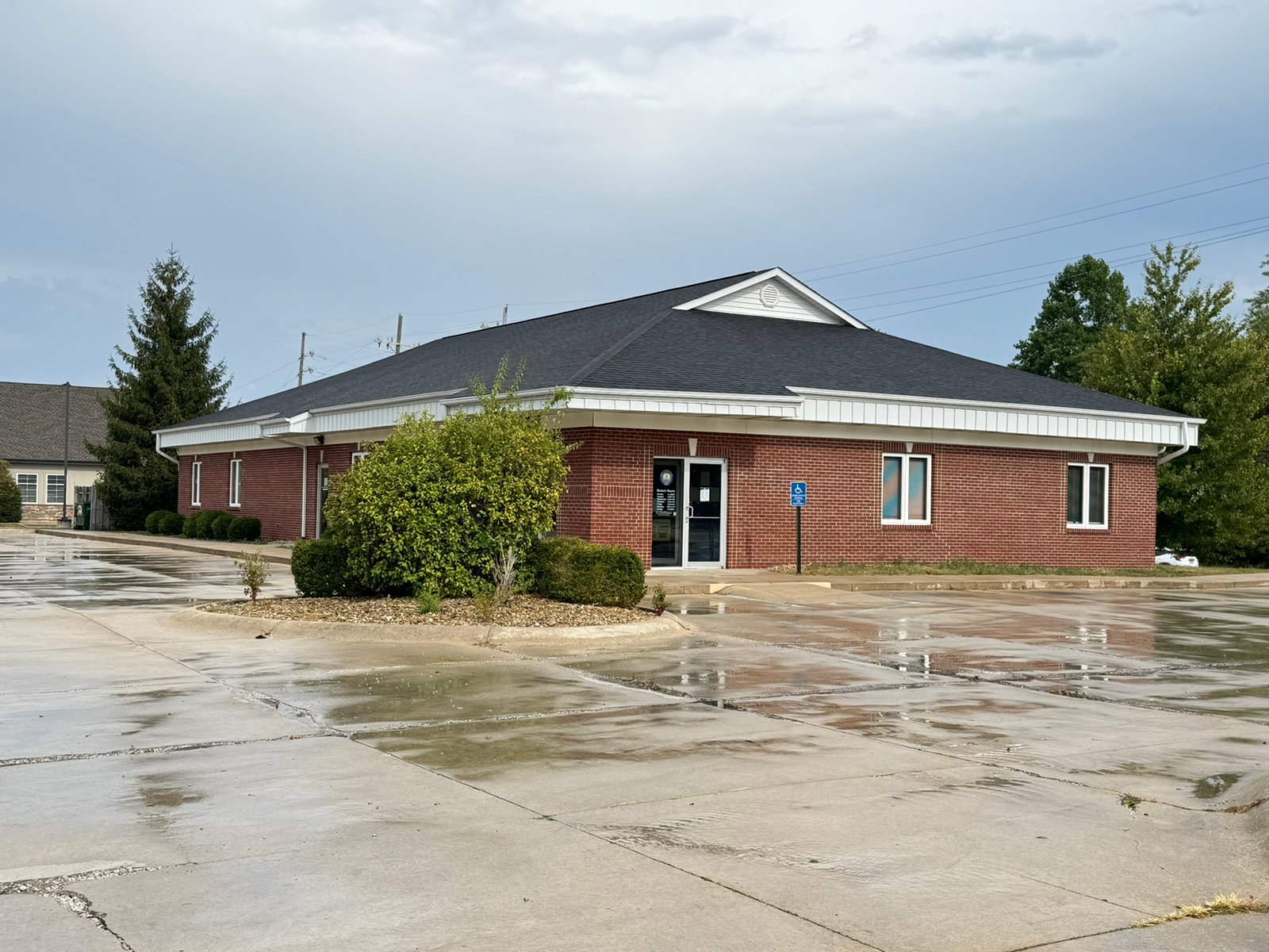 Outstanding opportunity to acquire a commercial property in Greencastle, IN with a proven long-term tenant. This site has been home to the Indiana Bureau of Motor Vehicles for more than 20 years under a favorable lease, ensuring minimal landlord responsibilities. With the current tenant there are no real estate taxes on the property.
The property spans 0.98+/- acres and includes a 4,947+/- sq ft building, built in 2004, along with a 15,180+/- sq ft parking lot providing ample customer convenience. The location is excellent - situated in Greencastle  Township, just East of Greencastle High School. With easy access from Veterans Memorial Highway (US-231) via Mill Pond Drive, the site benefits from both visibility and accessibility.
With a strong, creditworthy tenant and reliable cash flow, this property is an ideal choice for investors looking for secure, long-term income in a community-centered market. - COMMERCIAL REAL ESTATE FOR SALE - .98+/-ACRES IN PUTNAM COUNTY, INDIANA