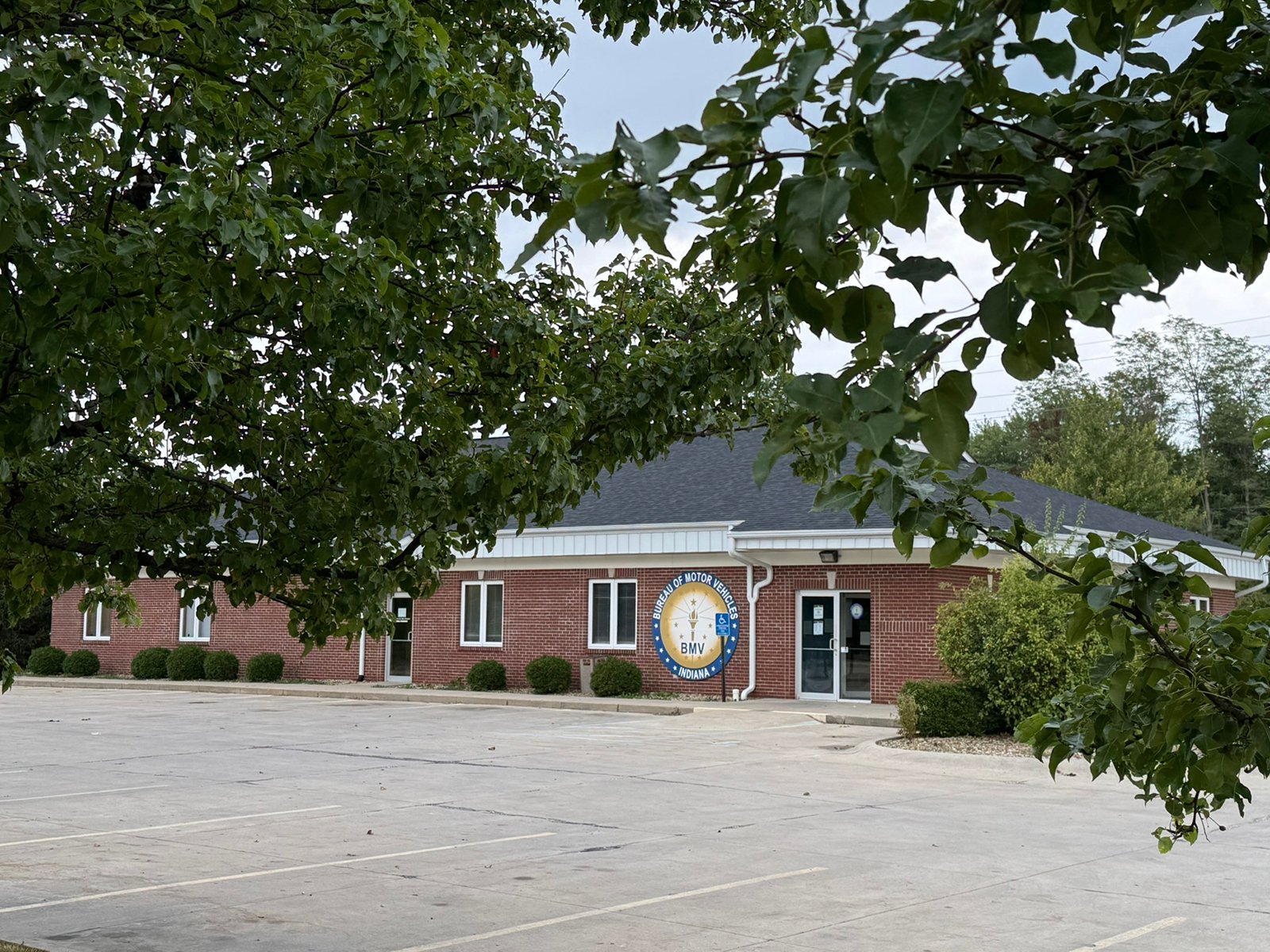 Outstanding opportunity to acquire a commercial property in Greencastle, IN with a proven long-term tenant. This site has been home to the Indiana Bureau of Motor Vehicles for more than 20 years under a favorable lease, ensuring minimal landlord responsibilities. With the current tenant there are no real estate taxes on the property.
The property spans 0.98+/- acres and includes a 4,947+/- sq ft building, built in 2004, along with a 15,180+/- sq ft parking lot providing ample customer convenience. The location is excellent - situated in Greencastle  Township, just East of Greencastle High School. With easy access from Veterans Memorial Highway (US-231) via Mill Pond Drive, the site benefits from both visibility and accessibility.
With a strong, creditworthy tenant and reliable cash flow, this property is an ideal choice for investors looking for secure, long-term income in a community-centered market. - COMMERCIAL REAL ESTATE FOR SALE - .98+/-ACRES IN PUTNAM COUNTY, INDIANA