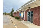 Outstanding opportunity to acquire a commercial property in Greencastle, IN with a proven long-term tenant. This site has been home to the Indiana Bureau of Motor Vehicles for more than 20 years under a favorable lease, ensuring minimal landlord responsibilities. With the current tenant there are no real estate taxes on the property.
The property spans 0.98+/- acres and includes a 4,947+/- sq ft building, built in 2004, along with a 15,180+/- sq ft parking lot providing ample customer convenience. The location is excellent - situated in Greencastle Township, just East of Greencastle High School. With easy access from Veterans Memorial Highway (US-231) via Mill Pond Drive, the site benefits from both visibility and accessibility.
With a strong, creditworthy tenant and reliable cash flow, this property is an ideal choice for investors looking for secure, long-term income in a community-centered market. - COMMERCIAL REAL ESTATE FOR SALE - .98+/-ACRES IN PUTNAM COUNTY, INDIANA