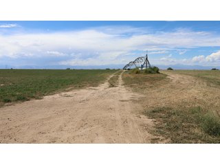 An opportunity to acquire approximately 280+/- acres along County Road 8 in southern Weld County. Strategically positioned between Fort Lupton and Brighton, the property consists of two contiguous parcels under common ownership and offers the scale and configuration to support agricultural operations, long-term investment, or future employment, industrial, technology and energy development.<BR><BR>
The property is presently zoned Agricultural in unincorporated Weld County. Its substantial acreage and location within the growing US Highway 85 and Interstate 76 corridor provide a strong foundation for a buyer prepared to evaluate zoning, infrastructure and development alternatives.<BR><BR>
Water interests include shares in the Wellington Reservoir Company, Burlington Ditch Reservoir and Land Company, and Brighton Lateral Ditch Company. Ownership, conveyance terms, historical use, transferable yield and suitability for future development remain subject to verification.<BR><BR>
The property provides access to the northern Denver metropolitan area, Denver International Airport and expanding Weld County employment centers. Existing agricultural use offers an interim holding strategy while a purchaser evaluates potential development plans and required approvals.<BR><BR>
Prospective purchasers should independently verify acreage, boundaries, access, zoning, permitted uses, utility availability and capacity, water rights, environmental conditions, mineral interests and development feasibility. No survey is being provided, and all future development concepts are subject to governmental and utility-provider approvals. - LAND FOR SALE - 280+/-ACRES IN WELD COUNTY, COLORADO