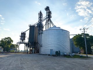 The Frick Grain and Agronomy site facilities are situated on approximately 35+/- acres and represent a rare, large-scale agribusiness operation ready for immediate use.<BR>
The grain system offers an impressive 1,660,000-bushel capacity across six bins. The tower grain dryer operates at 4,000 bu/hr at 5-point moisture removal, ensuring efficient drying capacity for high-volume harvests. The west grain facility features a grain leg capacity of 6,000 bu/hr, while the east grain facility boasts a robust 10,000 bu/hr grain leg capacity. Supporting the drying operation is an 8,000-bushel wet holding bin that feeds directly into the dryer, along with 12,000-bushel overhead load bins. The property also includes an 18,000-gallon LP tank to power operations.<br>
The agronomy infrastructure is equally impressive, featuring over 2,100,000 gallons of liquid fertilizer storage with a covered loadout facility for liquid products. A 500-ton dry fertilizer building with 8 bays provides ample space, complete with blending and loading equipment. The commercial chemical building houses 10 stainless steel tanks with over 30,000 gallons of bulk herbicide storage, equipped with a fully piped, computerized mixing system and covered loadout structure. Additional storage includes a 60' x 80' heated commercial shop building and a 50' x 90' storage building with a tote rack system for chemicals and seed.<br>
The facility enjoys direct access to the Norfolk Southern Railroad, with a large rail siding capable of receiving tanker cars and loading grain onto railcars. A dedicated piping system allows for the direct unloading of tanker cars into the two 1,000,000-gallon liquid tanks. Weighing operations are handled by a heavy-duty 120,000-pound capacity in-ground scale.<br>
As an added income stream, a telecommunications tower located on the west end of the property generates $9,268 in annual income, with an escalator clause providing year-over-year growth.<br>
Please refer to the improvement chart for dates and dimensions of all structures located on the facility.<br>
This is an extremely rare opportunity to acquire this level of grain handling and storage capacity, agronomy infrastructure, and overall square footage - all at a compelling price point. Don't miss your chance to own one of the most well-equipped agricultural facilities available on the market today! - GRAIN FACILITY FOR SALE - 35+/-ACRES IN NOBLE COUNTY, INDIANA