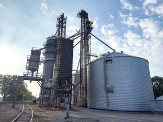 The Frick Grain and Agronomy site facilities are situated on approximately 35+/- acres and represent a rare, large-scale agribusiness operation ready for immediate use.<BR>
The grain system offers an impressive 1,660,000-bushel capacity across six bins. The tower grain dryer operates at 4,000 bu/hr at 5-point moisture removal, ensuring efficient drying capacity for high-volume harvests. The west grain facility features a grain leg capacity of 6,000 bu/hr, while the east grain facility boasts a robust 10,000 bu/hr grain leg capacity. Supporting the drying operation is an 8,000-bushel wet holding bin that feeds directly into the dryer, along with 12,000-bushel overhead load bins. The property also includes an 18,000-gallon LP tank to power operations.<br>
The agronomy infrastructure is equally impressive, featuring over 2,100,000 gallons of liquid fertilizer storage with a covered loadout facility for liquid products. A 500-ton dry fertilizer building with 8 bays provides ample space, complete with blending and loading equipment. The commercial chemical building houses 10 stainless steel tanks with over 30,000 gallons of bulk herbicide storage, equipped with a fully piped, computerized mixing system and covered loadout structure. Additional storage includes a 60' x 80' heated commercial shop building and a 50' x 90' storage building with a tote rack system for chemicals and seed.<br>
The facility enjoys direct access to the Norfolk Southern Railroad, with a large rail siding capable of receiving tanker cars and loading grain onto railcars. A dedicated piping system allows for the direct unloading of tanker cars into the two 1,000,000-gallon liquid tanks. Weighing operations are handled by a heavy-duty 120,000-pound capacity in-ground scale.<br>
As an added income stream, a telecommunications tower located on the west end of the property generates $9,268 in annual income, with an escalator clause providing year-over-year growth.<br>
Please refer to the improvement chart for dates and dimensions of all structures located on the facility.<br>
This is an extremely rare opportunity to acquire this level of grain handling and storage capacity, agronomy infrastructure, and overall square footage - all at a compelling price point. Don't miss your chance to own one of the most well-equipped agricultural facilities available on the market today! - GRAIN FACILITY FOR SALE - 35+/-ACRES IN NOBLE COUNTY, INDIANA