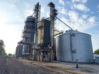 The Frick Grain and Agronomy site facilities are situated on approximately 35+/- acres and represent a rare, large-scale agribusiness operation ready for immediate use.<BR>
The grain system offers an impressive 1,660,000-bushel capacity across six bins. The tower grain dryer operates at 4,000 bu/hr at 5-point moisture removal, ensuring efficient drying capacity for high-volume harvests. The west grain facility features a grain leg capacity of 6,000 bu/hr, while the east grain facility boasts a robust 10,000 bu/hr grain leg capacity. Supporting the drying operation is an 8,000-bushel wet holding bin that feeds directly into the dryer, along with 12,000-bushel overhead load bins. The property also includes an 18,000-gallon LP tank to power operations.<br>
The agronomy infrastructure is equally impressive, featuring over 2,100,000 gallons of liquid fertilizer storage with a covered loadout facility for liquid products. A 500-ton dry fertilizer building with 8 bays provides ample space, complete with blending and loading equipment. The commercial chemical building houses 10 stainless steel tanks with over 30,000 gallons of bulk herbicide storage, equipped with a fully piped, computerized mixing system and covered loadout structure. Additional storage includes a 60' x 80' heated commercial shop building and a 50' x 90' storage building with a tote rack system for chemicals and seed.<br>
The facility enjoys direct access to the Norfolk Southern Railroad, with a large rail siding capable of receiving tanker cars and loading grain onto railcars. A dedicated piping system allows for the direct unloading of tanker cars into the two 1,000,000-gallon liquid tanks. Weighing operations are handled by a heavy-duty 120,000-pound capacity in-ground scale.<br>
As an added income stream, a telecommunications tower located on the west end of the property generates $9,268 in annual income, with an escalator clause providing year-over-year growth.<br>
Please refer to the improvement chart for dates and dimensions of all structures located on the facility.<br>
This is an extremely rare opportunity to acquire this level of grain handling and storage capacity, agronomy infrastructure, and overall square footage - all at a compelling price point. Don't miss your chance to own one of the most well-equipped agricultural facilities available on the market today! - GRAIN FACILITY FOR SALE - 35+/-ACRES IN NOBLE COUNTY, INDIANA