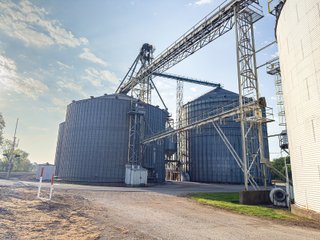 The Frick Grain and Agronomy site facilities are situated on approximately 35+/- acres and represent a rare, large-scale agribusiness operation ready for immediate use.<BR>
The grain system offers an impressive 1,660,000-bushel capacity across six bins. The tower grain dryer operates at 4,000 bu/hr at 5-point moisture removal, ensuring efficient drying capacity for high-volume harvests. The west grain facility features a grain leg capacity of 6,000 bu/hr, while the east grain facility boasts a robust 10,000 bu/hr grain leg capacity. Supporting the drying operation is an 8,000-bushel wet holding bin that feeds directly into the dryer, along with 12,000-bushel overhead load bins. The property also includes an 18,000-gallon LP tank to power operations.<br>
The agronomy infrastructure is equally impressive, featuring over 2,100,000 gallons of liquid fertilizer storage with a covered loadout facility for liquid products. A 500-ton dry fertilizer building with 8 bays provides ample space, complete with blending and loading equipment. The commercial chemical building houses 10 stainless steel tanks with over 30,000 gallons of bulk herbicide storage, equipped with a fully piped, computerized mixing system and covered loadout structure. Additional storage includes a 60' x 80' heated commercial shop building and a 50' x 90' storage building with a tote rack system for chemicals and seed.<br>
The facility enjoys direct access to the Norfolk Southern Railroad, with a large rail siding capable of receiving tanker cars and loading grain onto railcars. A dedicated piping system allows for the direct unloading of tanker cars into the two 1,000,000-gallon liquid tanks. Weighing operations are handled by a heavy-duty 120,000-pound capacity in-ground scale.<br>
As an added income stream, a telecommunications tower located on the west end of the property generates $9,268 in annual income, with an escalator clause providing year-over-year growth.<br>
Please refer to the improvement chart for dates and dimensions of all structures located on the facility.<br>
This is an extremely rare opportunity to acquire this level of grain handling and storage capacity, agronomy infrastructure, and overall square footage - all at a compelling price point. Don't miss your chance to own one of the most well-equipped agricultural facilities available on the market today! - GRAIN FACILITY FOR SALE - 35+/-ACRES IN NOBLE COUNTY, INDIANA