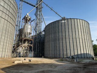 The Frick Grain and Agronomy site facilities are situated on approximately 35+/- acres and represent a rare, large-scale agribusiness operation ready for immediate use.<BR>
The grain system offers an impressive 1,660,000-bushel capacity across six bins. The tower grain dryer operates at 4,000 bu/hr at 5-point moisture removal, ensuring efficient drying capacity for high-volume harvests. The west grain facility features a grain leg capacity of 6,000 bu/hr, while the east grain facility boasts a robust 10,000 bu/hr grain leg capacity. Supporting the drying operation is an 8,000-bushel wet holding bin that feeds directly into the dryer, along with 12,000-bushel overhead load bins. The property also includes an 18,000-gallon LP tank to power operations.<br>
The agronomy infrastructure is equally impressive, featuring over 2,100,000 gallons of liquid fertilizer storage with a covered loadout facility for liquid products. A 500-ton dry fertilizer building with 8 bays provides ample space, complete with blending and loading equipment. The commercial chemical building houses 10 stainless steel tanks with over 30,000 gallons of bulk herbicide storage, equipped with a fully piped, computerized mixing system and covered loadout structure. Additional storage includes a 60' x 80' heated commercial shop building and a 50' x 90' storage building with a tote rack system for chemicals and seed.<br>
The facility enjoys direct access to the Norfolk Southern Railroad, with a large rail siding capable of receiving tanker cars and loading grain onto railcars. A dedicated piping system allows for the direct unloading of tanker cars into the two 1,000,000-gallon liquid tanks. Weighing operations are handled by a heavy-duty 120,000-pound capacity in-ground scale.<br>
As an added income stream, a telecommunications tower located on the west end of the property generates $9,268 in annual income, with an escalator clause providing year-over-year growth.<br>
Please refer to the improvement chart for dates and dimensions of all structures located on the facility.<br>
This is an extremely rare opportunity to acquire this level of grain handling and storage capacity, agronomy infrastructure, and overall square footage - all at a compelling price point. Don't miss your chance to own one of the most well-equipped agricultural facilities available on the market today! - GRAIN FACILITY FOR SALE - 35+/-ACRES IN NOBLE COUNTY, INDIANA