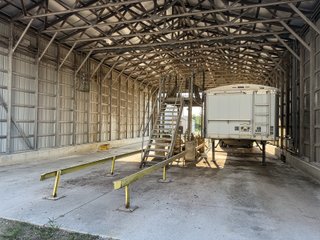 The Frick Grain and Agronomy site facilities are situated on approximately 35+/- acres and represent a rare, large-scale agribusiness operation ready for immediate use.<BR>
The grain system offers an impressive 1,660,000-bushel capacity across six bins. The tower grain dryer operates at 4,000 bu/hr at 5-point moisture removal, ensuring efficient drying capacity for high-volume harvests. The west grain facility features a grain leg capacity of 6,000 bu/hr, while the east grain facility boasts a robust 10,000 bu/hr grain leg capacity. Supporting the drying operation is an 8,000-bushel wet holding bin that feeds directly into the dryer, along with 12,000-bushel overhead load bins. The property also includes an 18,000-gallon LP tank to power operations.<br>
The agronomy infrastructure is equally impressive, featuring over 2,100,000 gallons of liquid fertilizer storage with a covered loadout facility for liquid products. A 500-ton dry fertilizer building with 8 bays provides ample space, complete with blending and loading equipment. The commercial chemical building houses 10 stainless steel tanks with over 30,000 gallons of bulk herbicide storage, equipped with a fully piped, computerized mixing system and covered loadout structure. Additional storage includes a 60' x 80' heated commercial shop building and a 50' x 90' storage building with a tote rack system for chemicals and seed.<br>
The facility enjoys direct access to the Norfolk Southern Railroad, with a large rail siding capable of receiving tanker cars and loading grain onto railcars. A dedicated piping system allows for the direct unloading of tanker cars into the two 1,000,000-gallon liquid tanks. Weighing operations are handled by a heavy-duty 120,000-pound capacity in-ground scale.<br>
As an added income stream, a telecommunications tower located on the west end of the property generates $9,268 in annual income, with an escalator clause providing year-over-year growth.<br>
Please refer to the improvement chart for dates and dimensions of all structures located on the facility.<br>
This is an extremely rare opportunity to acquire this level of grain handling and storage capacity, agronomy infrastructure, and overall square footage - all at a compelling price point. Don't miss your chance to own one of the most well-equipped agricultural facilities available on the market today! - GRAIN FACILITY FOR SALE - 35+/-ACRES IN NOBLE COUNTY, INDIANA
