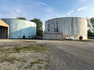 The Frick Grain and Agronomy site facilities are situated on approximately 35+/- acres and represent a rare, large-scale agribusiness operation ready for immediate use.<BR>
The grain system offers an impressive 1,660,000-bushel capacity across six bins. The tower grain dryer operates at 4,000 bu/hr at 5-point moisture removal, ensuring efficient drying capacity for high-volume harvests. The west grain facility features a grain leg capacity of 6,000 bu/hr, while the east grain facility boasts a robust 10,000 bu/hr grain leg capacity. Supporting the drying operation is an 8,000-bushel wet holding bin that feeds directly into the dryer, along with 12,000-bushel overhead load bins. The property also includes an 18,000-gallon LP tank to power operations.<br>
The agronomy infrastructure is equally impressive, featuring over 2,100,000 gallons of liquid fertilizer storage with a covered loadout facility for liquid products. A 500-ton dry fertilizer building with 8 bays provides ample space, complete with blending and loading equipment. The commercial chemical building houses 10 stainless steel tanks with over 30,000 gallons of bulk herbicide storage, equipped with a fully piped, computerized mixing system and covered loadout structure. Additional storage includes a 60' x 80' heated commercial shop building and a 50' x 90' storage building with a tote rack system for chemicals and seed.<br>
The facility enjoys direct access to the Norfolk Southern Railroad, with a large rail siding capable of receiving tanker cars and loading grain onto railcars. A dedicated piping system allows for the direct unloading of tanker cars into the two 1,000,000-gallon liquid tanks. Weighing operations are handled by a heavy-duty 120,000-pound capacity in-ground scale.<br>
As an added income stream, a telecommunications tower located on the west end of the property generates $9,268 in annual income, with an escalator clause providing year-over-year growth.<br>
Please refer to the improvement chart for dates and dimensions of all structures located on the facility.<br>
This is an extremely rare opportunity to acquire this level of grain handling and storage capacity, agronomy infrastructure, and overall square footage - all at a compelling price point. Don't miss your chance to own one of the most well-equipped agricultural facilities available on the market today! - GRAIN FACILITY FOR SALE - 35+/-ACRES IN NOBLE COUNTY, INDIANA